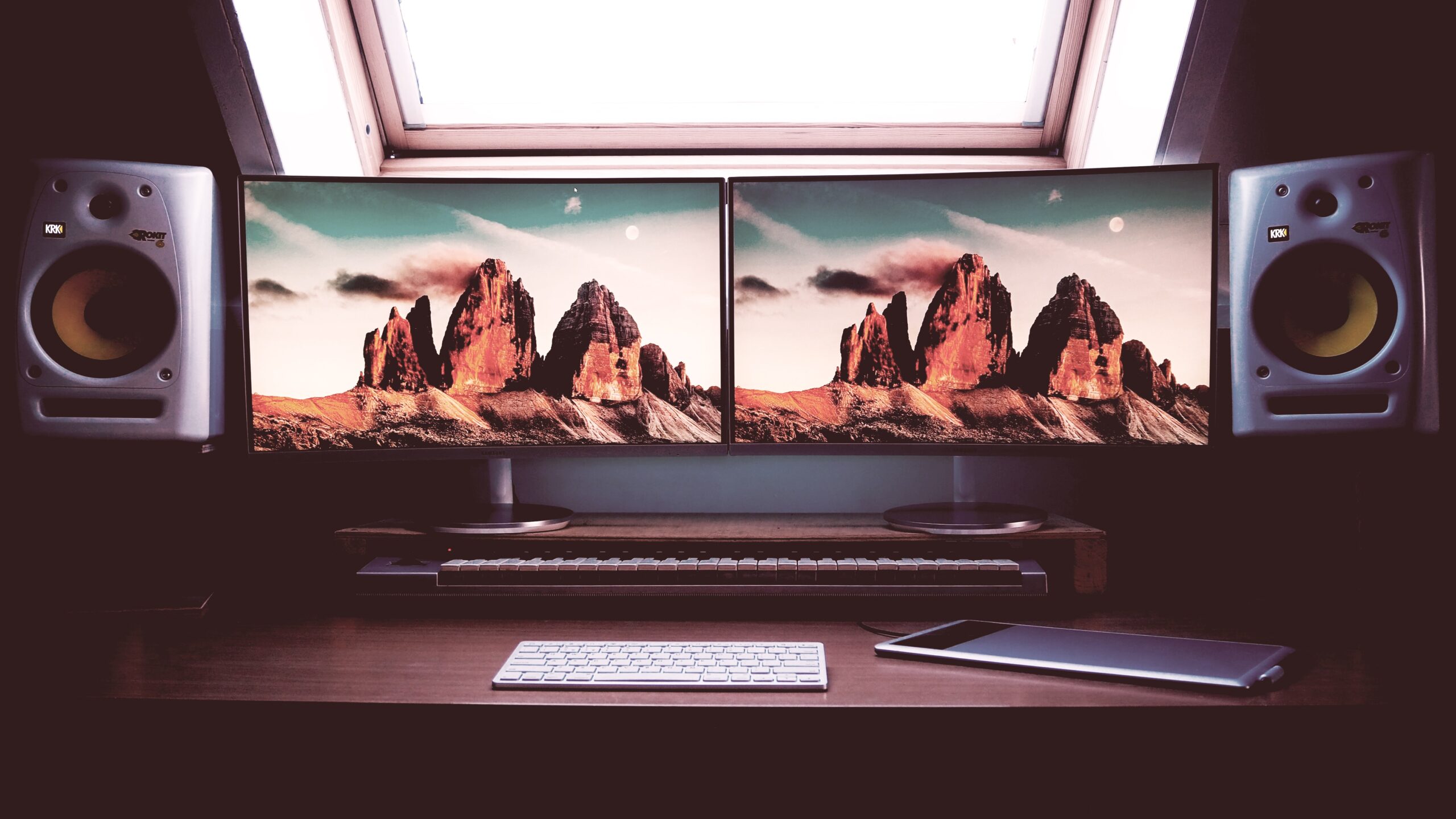 Handy Tips to Optimize a Dual-Monitor Setup for the Best Experience 1 turned on two flat screen computer monitors with speakers