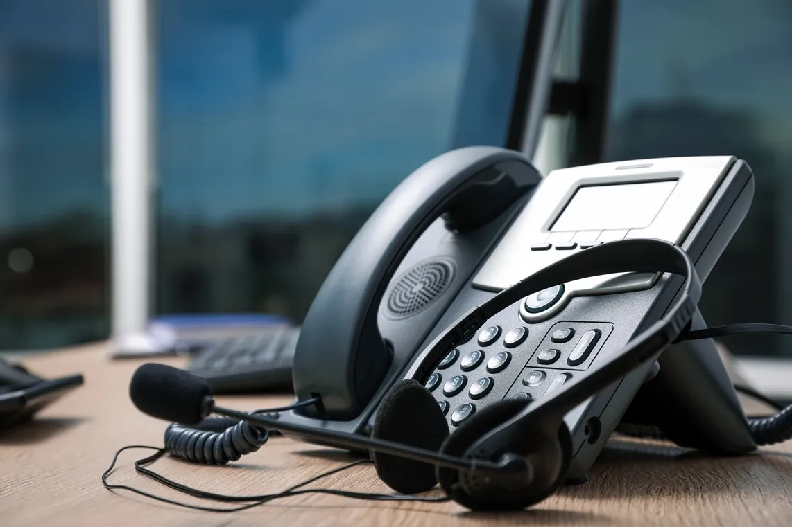 Desk phone with headset on office desk